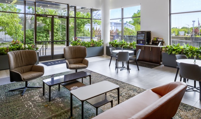 Motif Lobby lobby with large windows and ample seating areas with views of trees outside