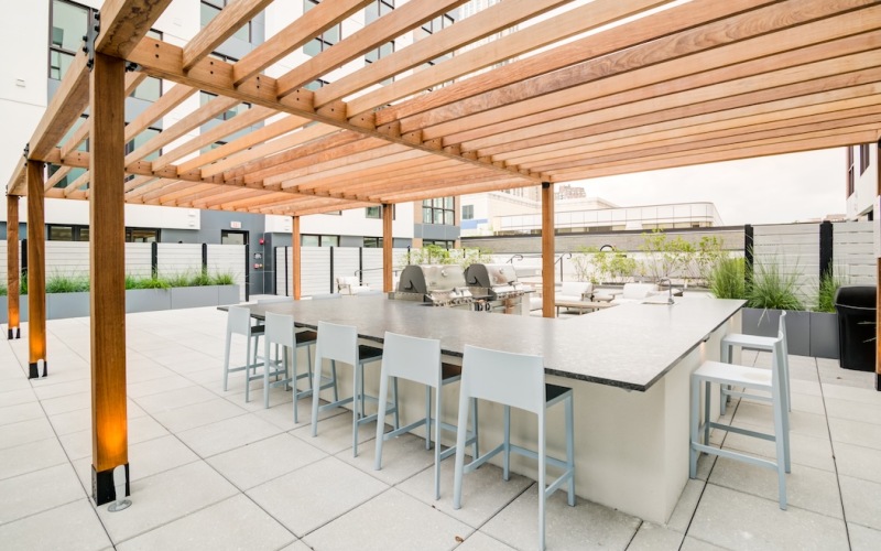 Outdoor courtyard of the Motif terrace with bar seating and grilling stations.