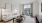 Living room in a Motif apartment home with a couch, table, and large NYC windows.