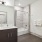 Modern bathroom with a sink, full height tiled bathtub/shower and toilet.