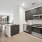 Spacious kitchen with modern appliances and dark brown finishes.