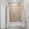 Bathroom tub with towels and a robe